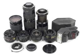 A collection of Canon and Canon FD fit lenses. To include a Canon 35mm 1:3.5, a Tamron 28mm 1:2.