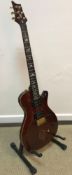 A Mikael Akerfeldt SE guitar for PRS Guitars with dark stained maple front and gilt decoration and