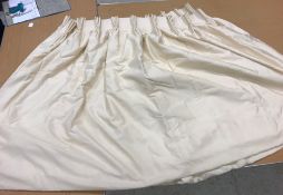 A pair of silk type cream interlined curtains with fixed triple pencil pleat headings,