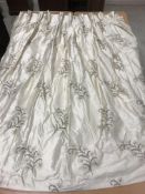 A pair of silk embroidered cream ground with foliate spray decorated interlined curtains with fixed