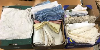 Three boxes of assorted table linens to include four lace tablecloths,
