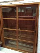 A pair of modern teak bookcase cabinets with sliding doors 150 cm wide x 50 cm deep x 190.