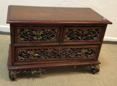 An Eastern (probably Thai) carved and painted hardwood dwarf chest of two short and one long drawer