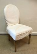 A set of eight OKA upholstered spoon back dining chairs on turned and fluted tapering legs to peg