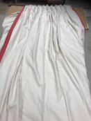 A pair of linen weave cream with raspberry pink border lined curtains with fixed triple pencil