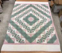 A modern Canadian patchwork quilt in whi