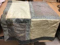 A modern cream and red silk table cover,