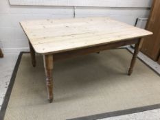 A scrubbed pine farmhouse kitchen table,