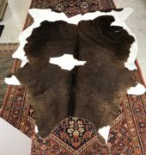 Taxidermy - A cow hide rug 241 cm x 189 cm bears label verso inscribed 