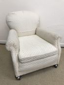 A Victorian scroll arm armchair, raised on bun feet and castors, 88 cm high,