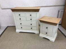 A modern cream painted chest of drawers,