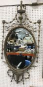 A gilt framed oval wall mirror in the Regency style with harebell and foliate open work decoration