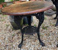Two cast iron pub tables with wooden tops