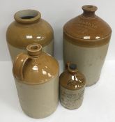 A collection of stoneware flagons, one inscribed 