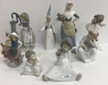 A collection of twelve Lladro figures including 