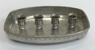 A collection of various candle holders including a Munka pewter four section candle stand,