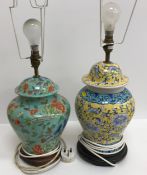 A set of three modern Chinese turquoise ground and polychrome decorated vase table lamps on wooden