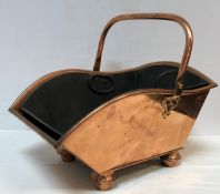A Victorian copper coal scuttle with swi