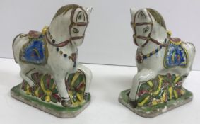 A pair of polychrome glazed faience pott