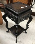 An Ercol elm single drop leaf occasional