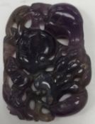 A Chinese carved amethyst pendant decora