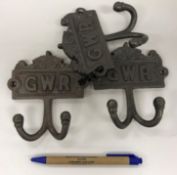 Two modern cast metal coat hooks inscribed 