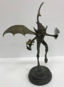 A modern verdigris and gilt bronze figure of a pixie, signed to base 