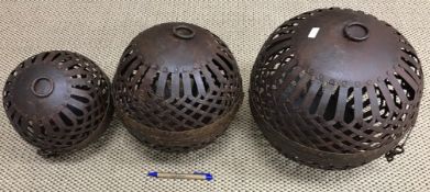 A set of three graduated metal spherical 