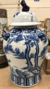 A modern blue and white Chinese vase and cover decorated with horses in a landscape,