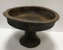 An 18th Century carved treenware pedestal bowl with slightly flared rim raised on a tapered foot 37