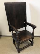 A 17th Century and later oak monk's chair, the associated three plank top with cleated ends,