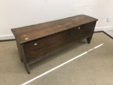 An 18th Century elm hutch of typical form, the single plank top carved with central stylised tulip,