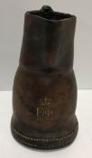 A small leather jack jug, gilt stamped 