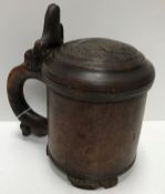 An 18th Century Norwegian burr birch tankard, the thumb piece as a seated lion,