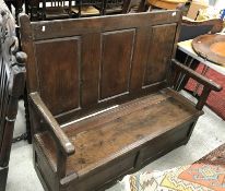 An 18th Century oak hall settle,