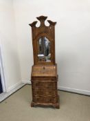A modern walnut bureau bookcase in the 18th Century Continental manner,