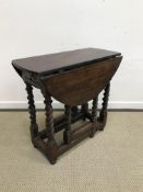 An 18th Century oak oval gate-leg drop-leaf tea table,