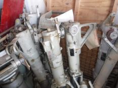 A collection of seven aeronautical suspension units, one bearing red stencilled number 