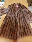 A selection of furs to include a musquash three quarter length coat with satin lining,