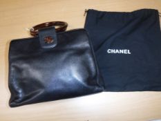 A Chanel black leather handbag with tortoiseshell style hoop handles and CC monogram No'd 5497011