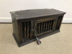 A 17th Century style oak food cupboard with moulded cornice above a galleried front with single