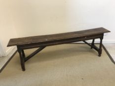 An 18th Century oak stool, the single plank top with moulded edge above a moulded frieze, on turned,