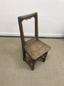 A pair of 18th Century open back panel seated hall chairs on turned supports united by stretchers,