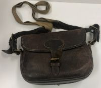A cowhide cartridge bag (75) embossed 