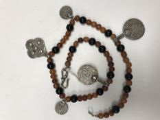 An amber beaded necklace with Eastern si
