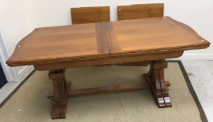 A modern walnut veneered extending dinin