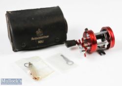 ABU Ambassadeur 2500C multiplying reel in red finish, foot stamped 070007, in maker's leatherette