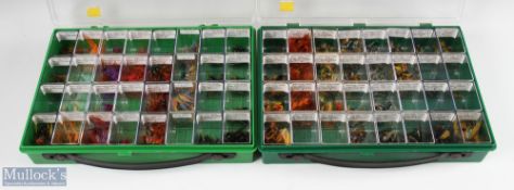 A plastic display case with 32 compartments with salmon double flies, made up of munro killer /