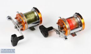 2x ABU Ambassadeur 6500 C3 CT Mag-Elite multiplier reels in orange finish, stamped 13001321 to the