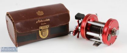 ABU Ambassadeur 6000 multiplier reel, in red, numbered to foot 010600, sliding line guide, runs